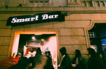 Smartbar entrance at a gay party in Chicago. People are queuing to enter the bar. Nightlife scene, gay travel advice.
