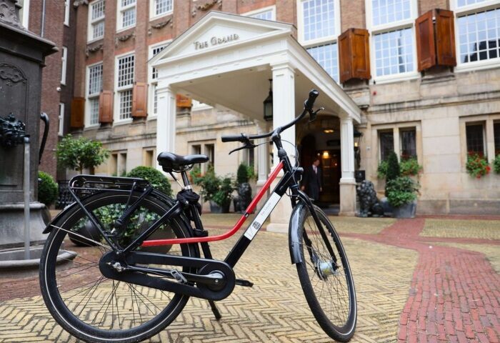 Bike in front of Sofitel Legend The Grand Amsterdam, a luxury gay-friendly hotel on a canal. Best hotel for gay men in Amsterdam.