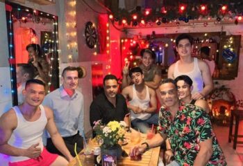 Space Hair Salon and Bar, Phnom Penh: A group of gay men at a bar in Cambodia, enjoying drinks and the vibrant atmosphere. Gay travel.