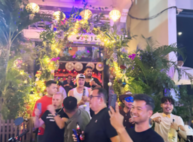 Space Hair Salon and Bar in Phnom Penh. Gay bar entrance with men posing. Gay travel advice for Cambodia's capital city. Nightlife.
