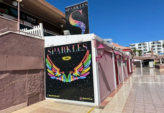 Sparkles Show Bar, a gay bar in Gran Canaria. Exterior view with colorful signage featuring the bar's name and rainbow wings.