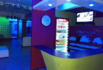 Spartacus Gay Sauna in Puerto Vallarta lobby. Drinks, towels, and a TV are visible. A great spot for gay men's travel.