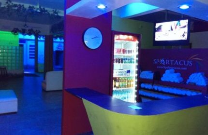 Spartacus Gay Sauna in Puerto Vallarta lobby. Drinks, towels, and a TV are visible. A great spot for gay men's travel.