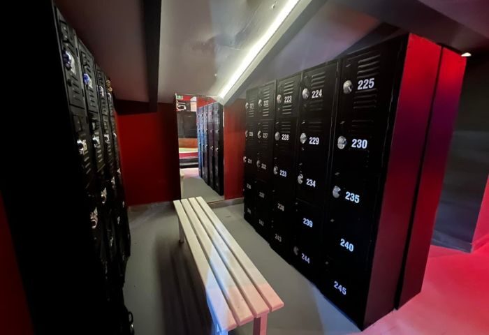 Lockers at Spartacus Gay Sauna in Puerto Vallarta. Black lockers line the wall with a bench in the foreground. Gay travel.