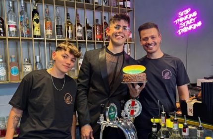 Spiritall Lounge Bar Rome staff. Gay bar with cocktails, beer, and cake. Stop Thinking Start Drinking neon sign. Gay travel advice.
