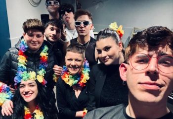Spiritall Lounge Bar Rome group photo. People wear rainbow leis, sunglasses. Gay travel advice, Rome nightlife.