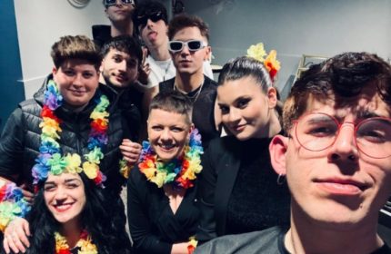 Spiritall Lounge Bar Rome group photo. People wear rainbow leis, sunglasses. Gay travel advice, Rome nightlife.