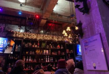 St Felix Hollywood night life. Interior of the gay bar in West Hollywood, CA. Shelves of curios, bottles, and patrons at the bar.