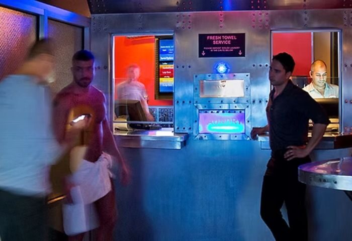 Steamworks Chicago: Men at the front desk of this gay gym and sauna in Chicago. Towel service and staff visible.