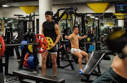 Steamworks Chicago gay gym: Men work out with weights and machines in a modern gym setting. Sauna and fitness for gay men's travel.