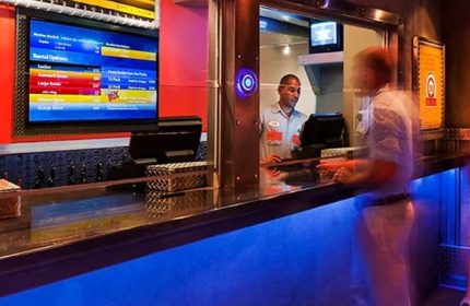 Steamworks Chicago: Front desk at the gay gym and sauna in Chicago. Man checking in at the counter with rental options on the screen.