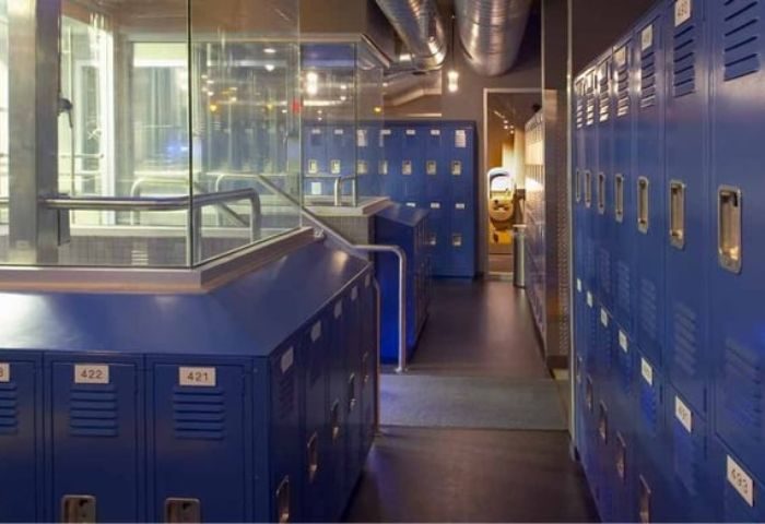 Toronto Steamworks locker room. Blue lockers line a dark hallway, leading to a steam room. Gay sauna travel advice.
