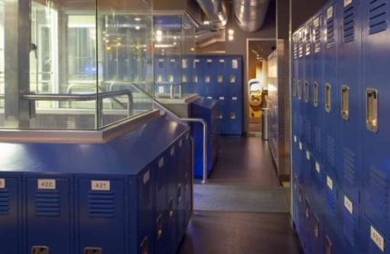 Toronto Steamworks locker room. Blue lockers line a dark hallway, leading to a steam room. Gay sauna travel advice.