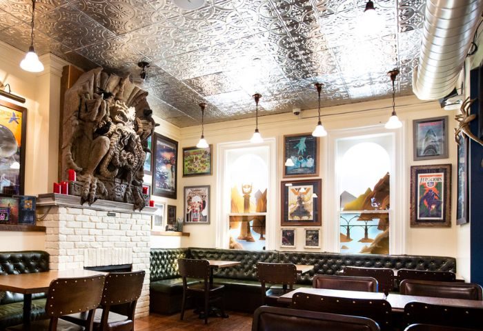 Storm Crow Manor interior, Toronto. Fantasy decor, tables, chairs, booths, and artwork. A quirky, must-see spot for gay travelers.