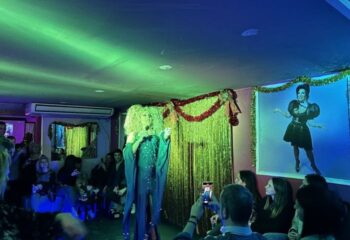 Strass Barcelona gay bar: Drag queen performing to an audience. Barcelona's gay nightlife offers exciting shows and a welcoming atmosphere.