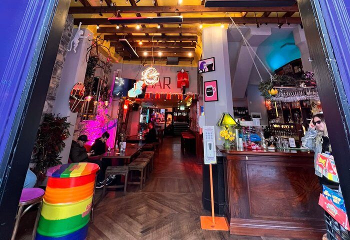 Interior of Street 66, a gay bar in Dublin. Features rainbow decor, neon signs, and a lively atmosphere. Dublin gay travel destination.