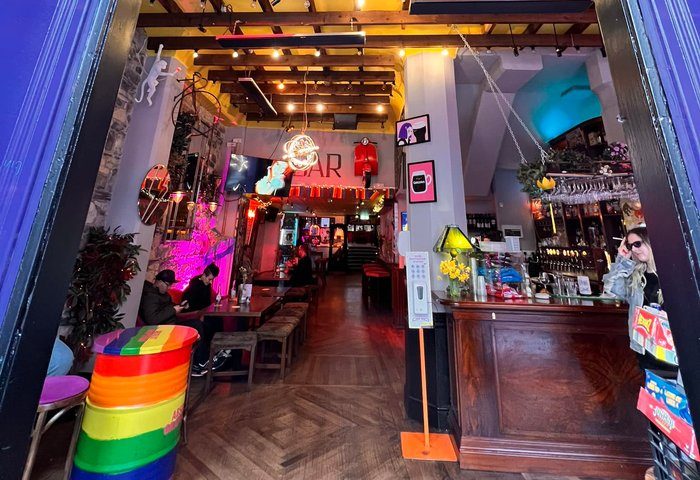 Interior of Street 66, a gay bar in Dublin. Features rainbow decor, neon signs, and a lively atmosphere. Dublin gay travel destination.