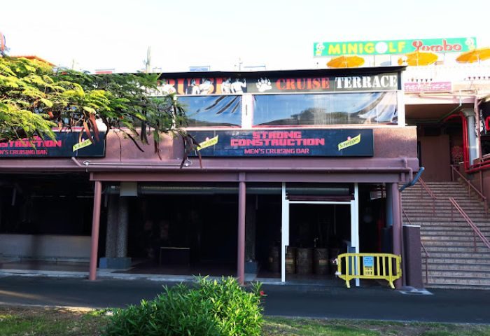 Strong Construction, a gay cruise club in Gran Canaria. Men's cruising bar. Exterior view of the club's entrance and signage.