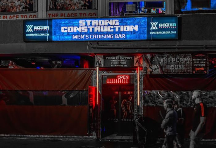 Strong Construction gay cruise club in Gran Canaria. Men's cruising bar exterior with OPEN sign. Gay travel destination.
