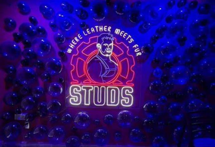 Neon sign for Studs Bear Bar, a gay place in Puerto Vallarta. It features a bear in leather harness and the words Where leather meets fur.