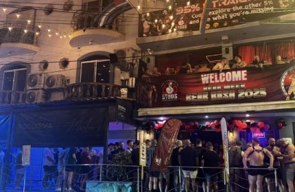 Studs Bear Bar, a gay place in Puerto Vallarta, during Bear Bash 2025. Men gather outside the bar, some wearing harnesses. Night scene, lively.