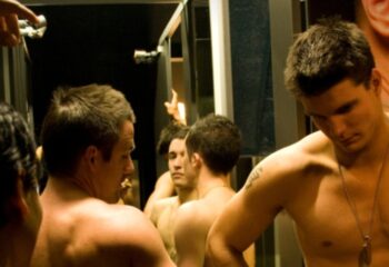 Melbourne sauna: Group of shirtless gay men reflected in a mirror. Gay travel advice, gay sauna, gay men's health.