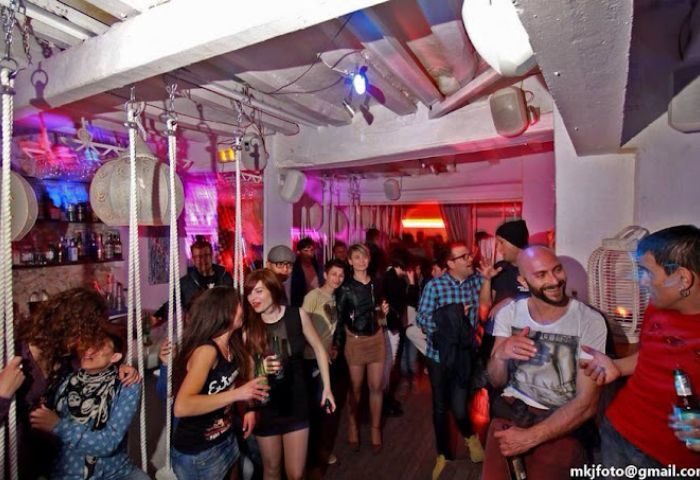 Sunrise Gay Bar in Ibiza: A vibrant nightlife scene with a diverse crowd enjoying drinks and socializing at a popular gay-friendly venue.