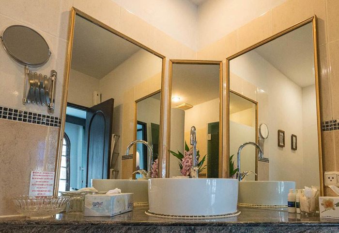 Poseidon Boutique Hotel bathroom. Super gay-friendly hotel in Pattaya near gay bars. Stylish sinks, mirrors, and amenities.
