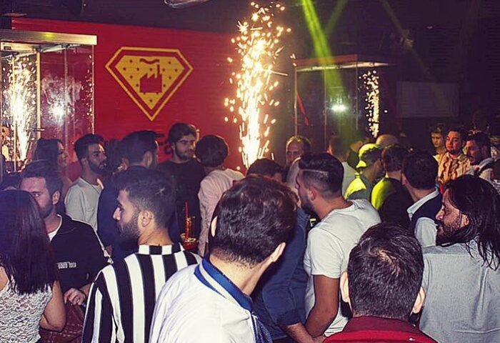 SuperFabric Club Istanbul crowd. Gay men enjoy the night with sparks and lights. Nightlife scene for gay travelers.