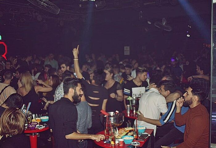Istanbul's SuperFabric Club scene. Gay men enjoy drinks, dance, and socialize in the vibrant, dark club setting. Nightlife travel advice.