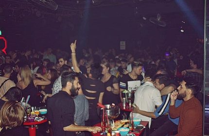 Istanbul's SuperFabric Club scene. Gay men enjoy drinks, dance, and socialize in the vibrant, dark club setting. Nightlife travel advice.