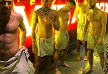 Sweatbox gay sauna in London: shirtless men in towels. London's gay scene offers saunas like Sweatbox for relaxation and socialising.