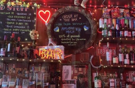 Sweaty Betty's Bar in Toronto: A quirky, gay-friendly bar with neon lights, cocktail menu, and Ukrainian relief fundraiser. Gay travel advice.