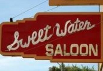 Sweetwater Saloon sign. A gay bar location for LGBT travel. Find gay-friendly bars and nightlife with Sweetwater Saloon, a popular destination.