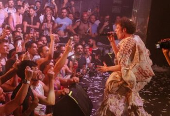 Singer performing at TANGA Party, a gay club in Barcelona. Crowd of gay men cheering and recording the performance with their phones.