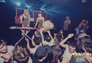 TANGA! Party at a gay club in Barcelona. Crowd of people dancing, performers on stage. Nightlife scene, LGBTQ+ travel destination.