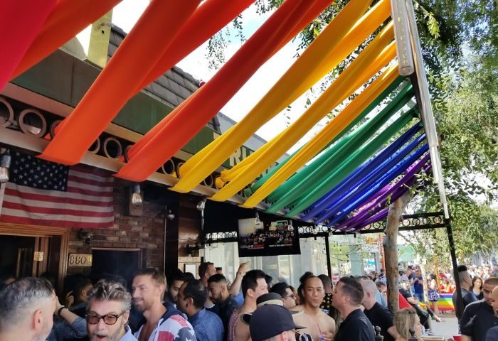 TRUNKS Outside: Gay bar with rainbow decorations & crowd. A popular gay travel destination, TRUNKS offers a vibrant, welcoming atmosphere.