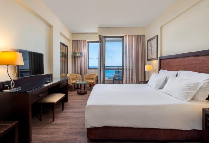 TUI Blue Gardens Savoy Signature adults-only hotel room. Gay-friendly Madeira hotel with balcony, sea view, desk, and king bed.