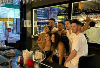 Gay travel: Group of friends at Terroir Wine Bar in Ho Chi Minh City, Vietnam. Enjoying drinks and nightlife. Fun, social scene.