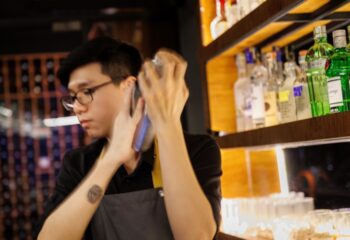 Bartender shaking cocktail at Terroir Wine Bar, Ho Chi Minh City. A gay travel destination for drinks and nightlife. Vietnam bar scene.