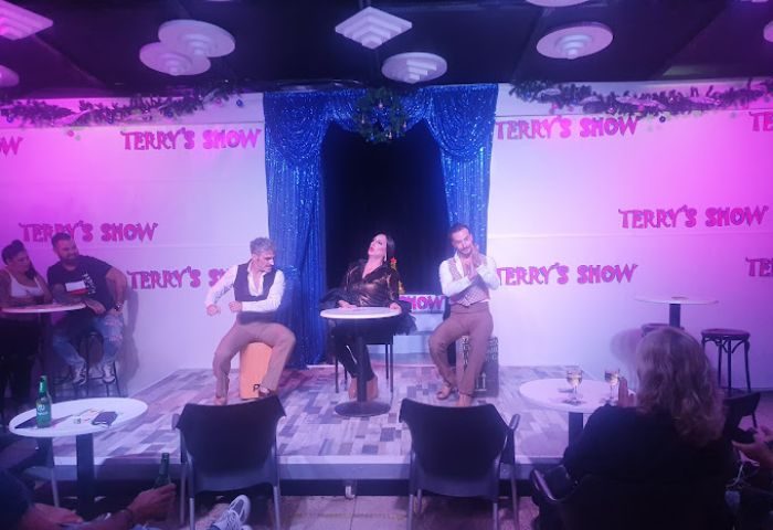 Terry's Show Bar, a gay bar in Gran Canaria. Performers on stage, audience members seated at tables. Nightlife & entertainment.