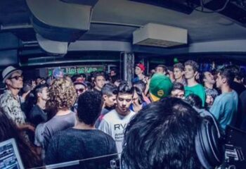 Crowded dance floor at The Basement Club, a gay cruise club in Barcelona. Gay nightlife scene with young men enjoying the party.