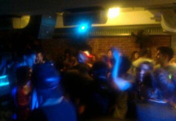 Inside The Basement Club, a gay cruise club in Barcelona. Crowded dance floor with men enjoying the music and lights. Gay travel destination.