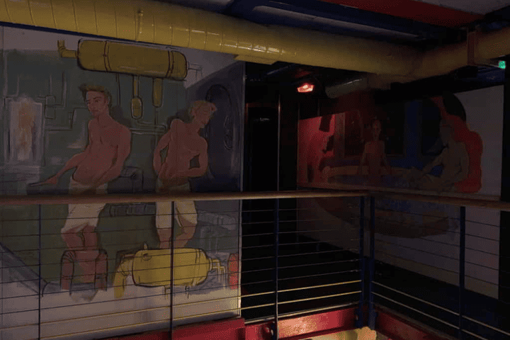 Interior of The Boilerhouse gay sauna in Dublin, Ireland. Wall art of men and equipment. Gay travel advice.
