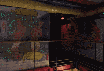 Interior of The Boilerhouse gay sauna in Dublin, Ireland. Wall art of men and equipment. Gay travel advice.