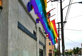 The Broadway Bar location: Rainbow flags adorn the exterior of The Broadway Bar, a gay bar, symbolizing LGBTQ+ pride and welcoming gay travelers.