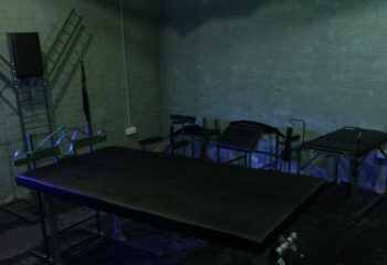 The Bunker London: Private appointment only gay cruise club. Dark room interior with various apparatus and furniture.