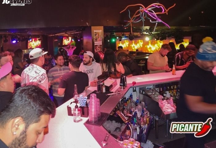 The Cafe Night Club in San Francisco: A lively bar scene with patrons enjoying drinks. Popular gay travel destination. Nightlife.