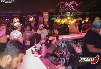 The Cafe Night Club in San Francisco: A lively bar scene with patrons enjoying drinks. Popular gay travel destination. Nightlife.