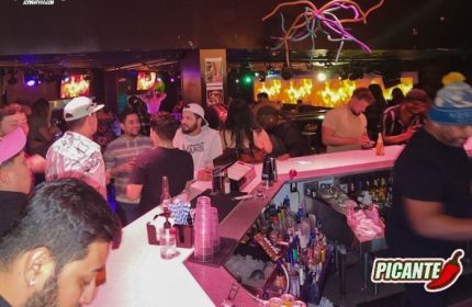 The Cafe Night Club in San Francisco: A lively bar scene with patrons enjoying drinks. Popular gay travel destination. Nightlife.